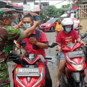 Di Pasar Kilometer Babinsa Perak Utara Bagikan Masker